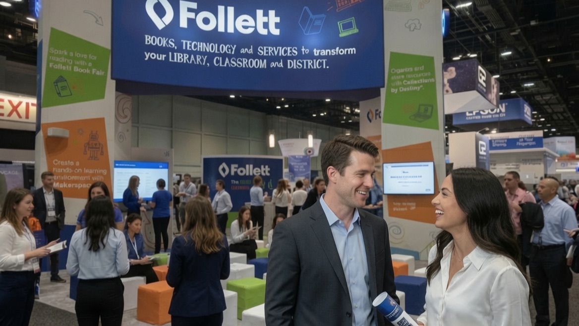 Two smiling attendees in the foreground of a busy trade-show aisle lined with booths and passing visitors